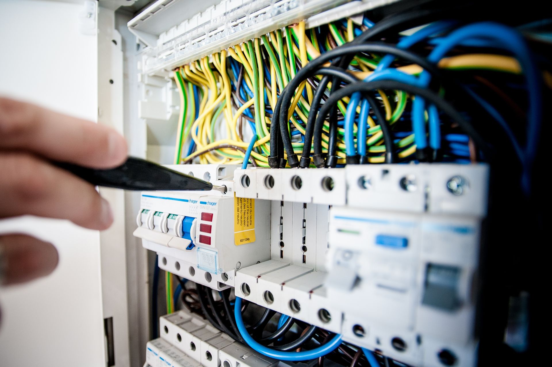 Electrician working on a commercial circuit breaker panel
