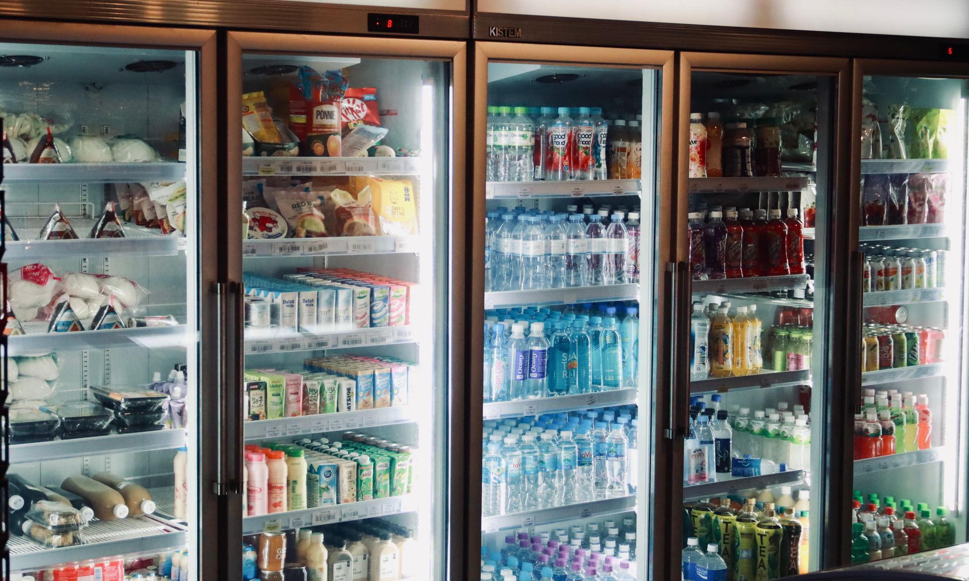 Refrigerated beverage and grocery display cases in a store