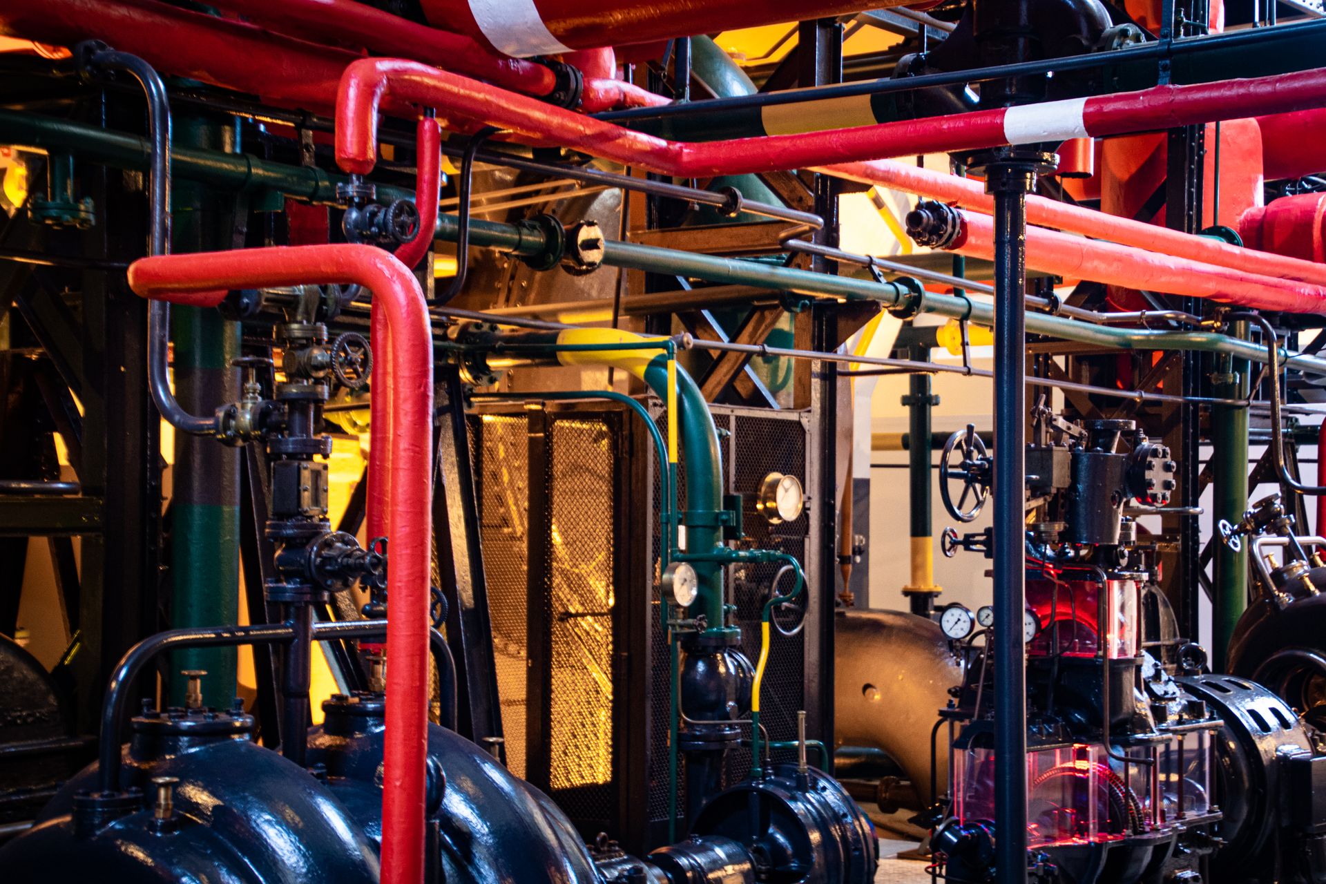 Industrial mechanical room with pipes, valves and pumps